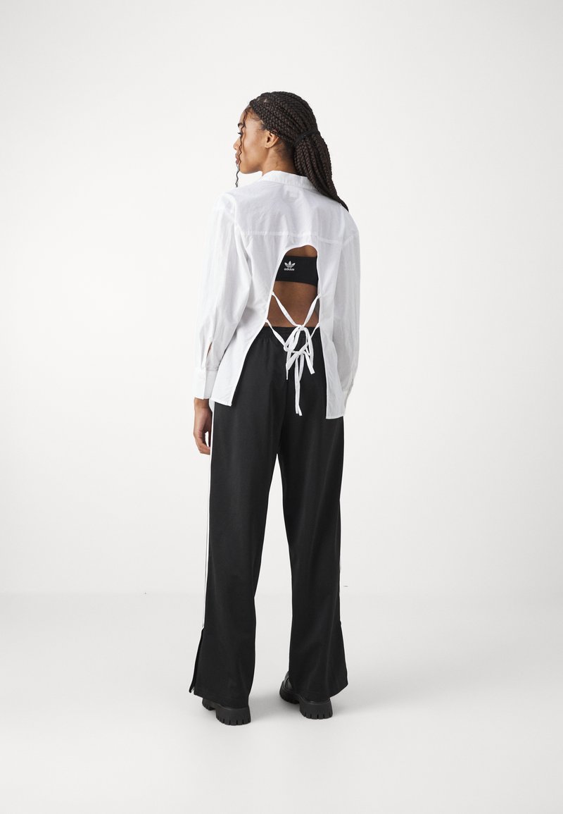 adidas Originals adidas Originals FBIRD LOOSE - Tracksuit bottoms - black Sonderangebot der Fabrik