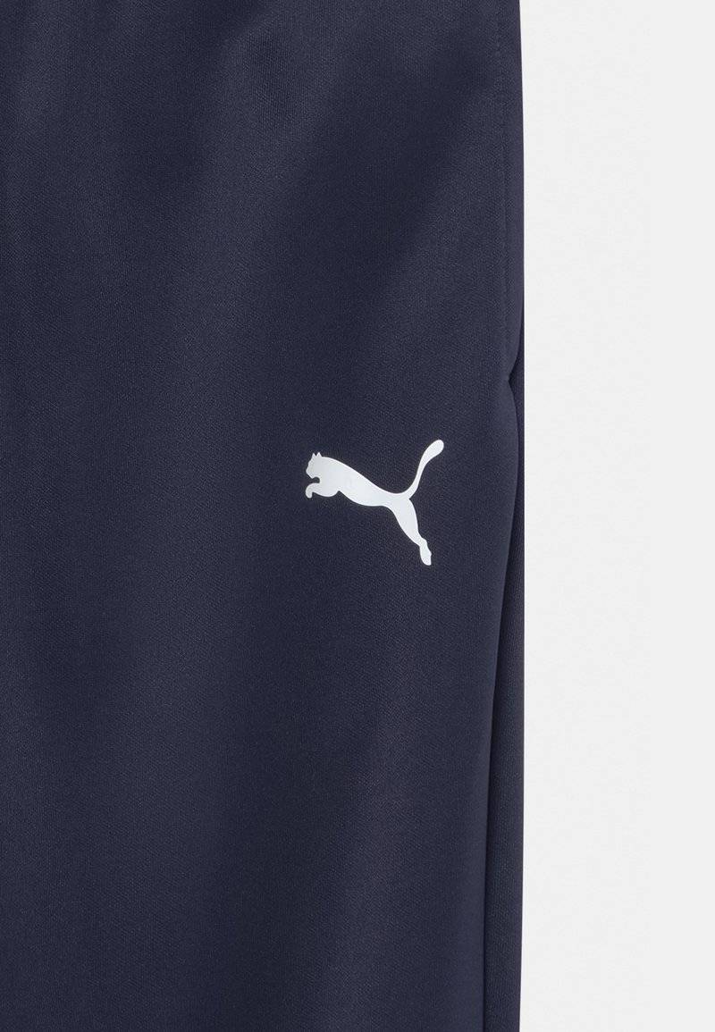 Puma Puma TEAMRISE POLY TRAINING UNISEX - Tracksuit bottoms 2025