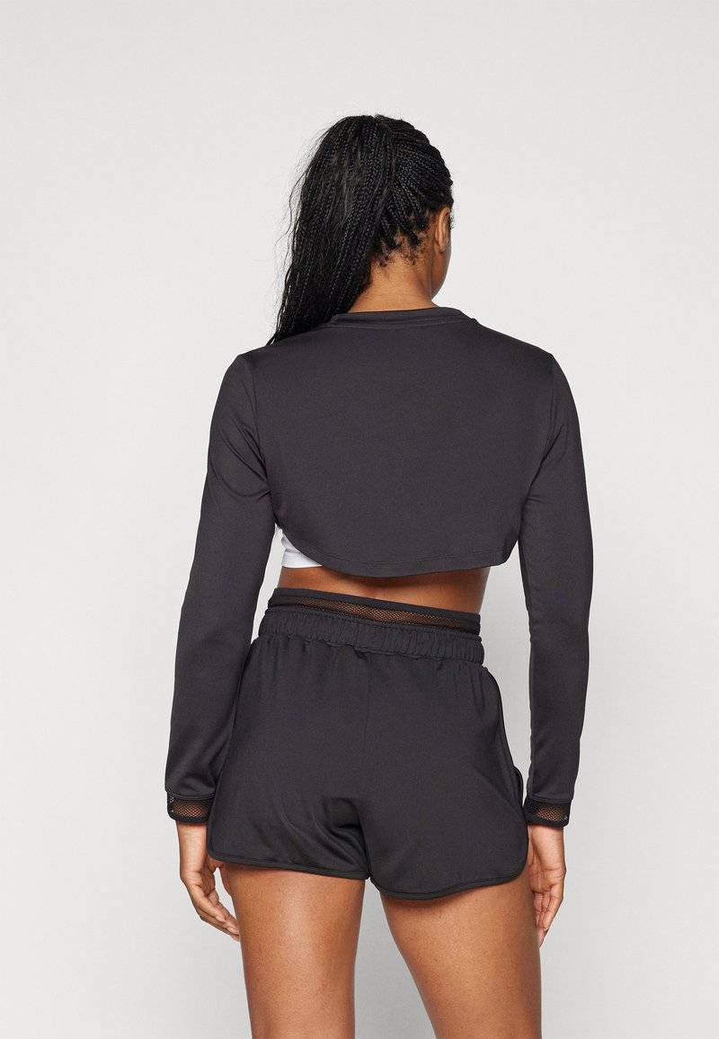 Puma Puma PAMELA REIF CROPPED - Long sleeved top - black Rabatte dieses Monats