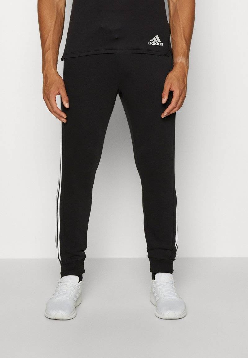adidas Sportswear adidas Sportswear ESSENTIALS TAPERED CUFF 3 STRIPES PANTS - Tracksuit bottoms - black white Fabrikverkauf