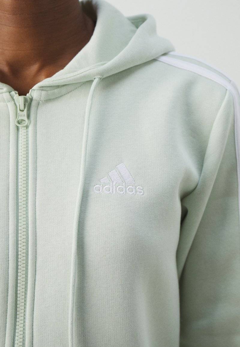 adidas Sportswear adidas Sportswear ESSENTIALS 3 STRIPES FULL ZIP HOODIE - Zip-up sweatshirt - linen green Bestseller