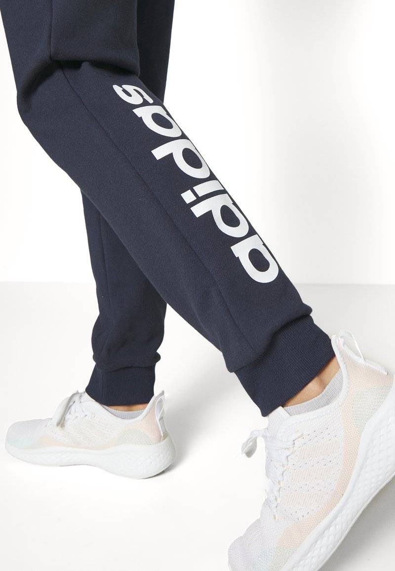 adidas Sportswear adidas Sportswear ESSENTIALS LINEAR CUFFED - Tracksuit bottoms - legend ink Kostenlose Rückgabe